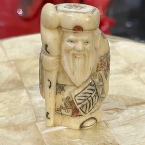 Carved bone figure of a Buddha about twenty five years old love the eyes
